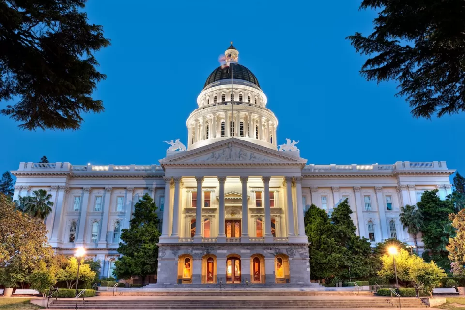 View of California State Capitol dome in Sacramento, California at dusk.